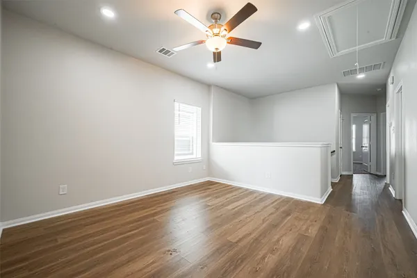 an empty room with windows and closet