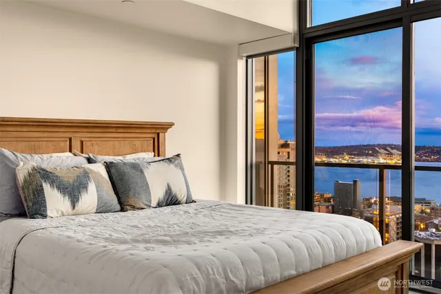 a living room with furniture and a floor to ceiling window