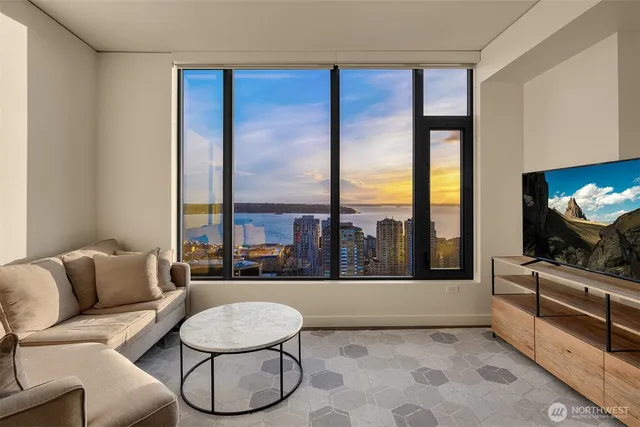 a living room with furniture and a floor to ceiling window