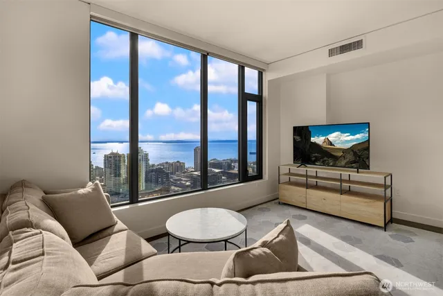 a bedroom with a large bed and a large window