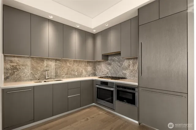 a kitchen with granite countertop white cabinets and white appliances