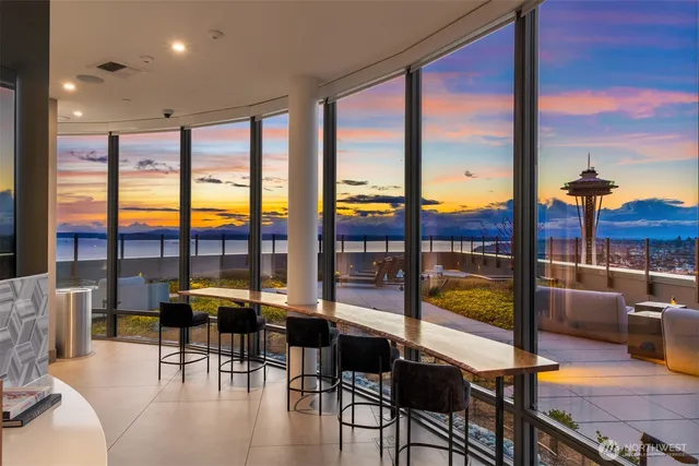 a living room with furniture city view and large windows