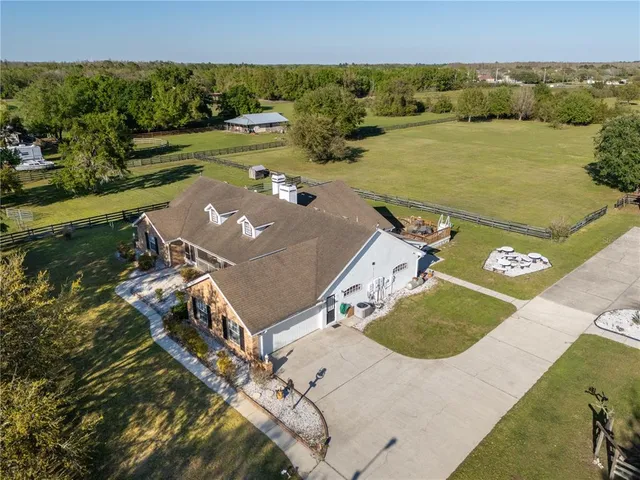 an aerial view of a house with garden space and ocean view