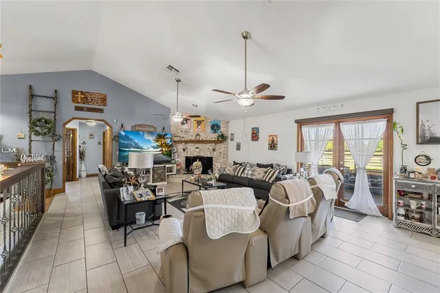 a view of a dining room with furniture a chandelier and wooden floor