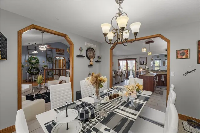 a bed sitting in a bedroom and a table in a bedroom