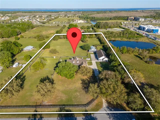 an aerial view of a house with a lake view