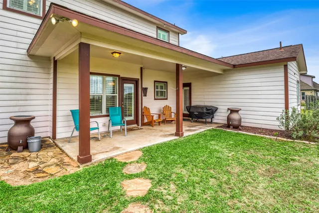 a view of a house with a yard porch and sitting area