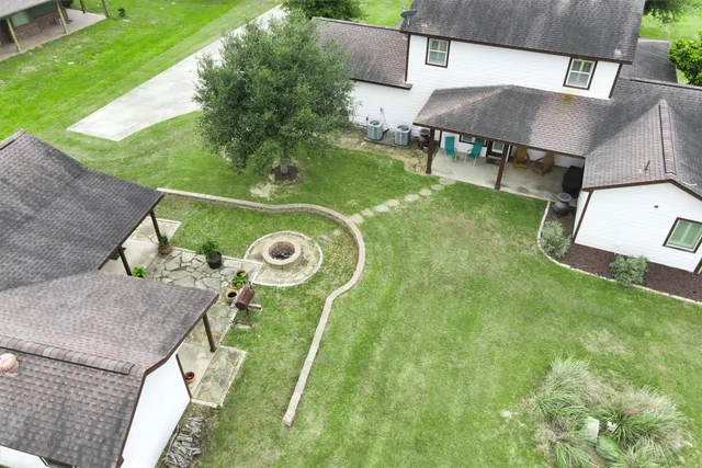 an aerial view of a residential houses with outdoor space and street view
