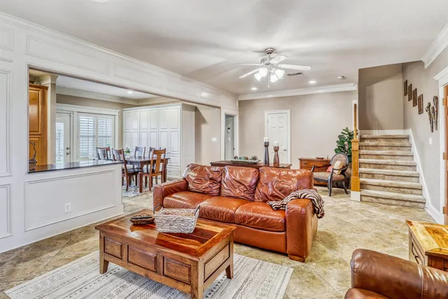 a living room with furniture and a chandelier