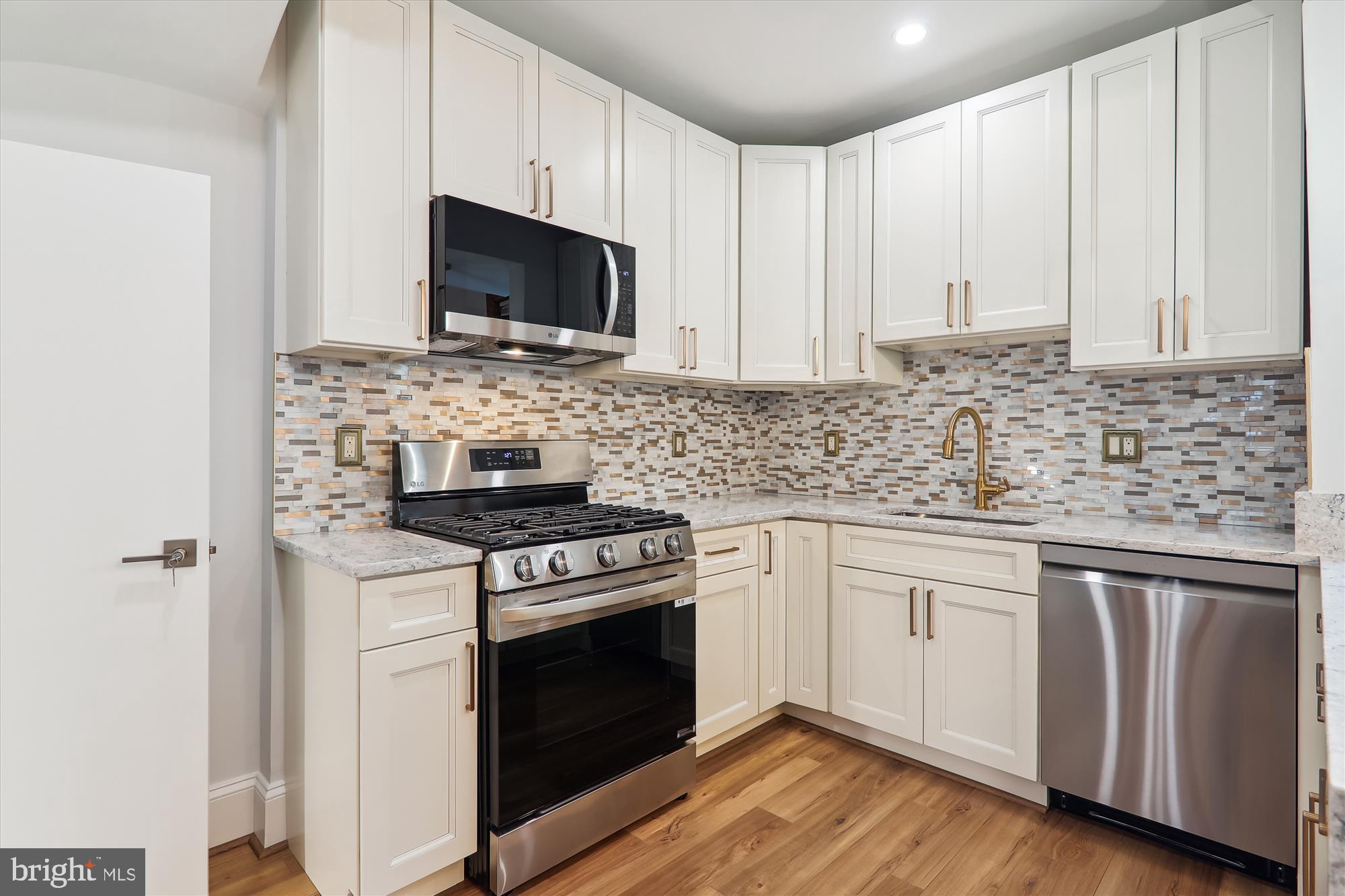 721 Quebec Place Northwest Washington, DC 20010 - Photo 16 of 77 a kitchen with stainless steel appliances granite countertop a stove microwave and sink