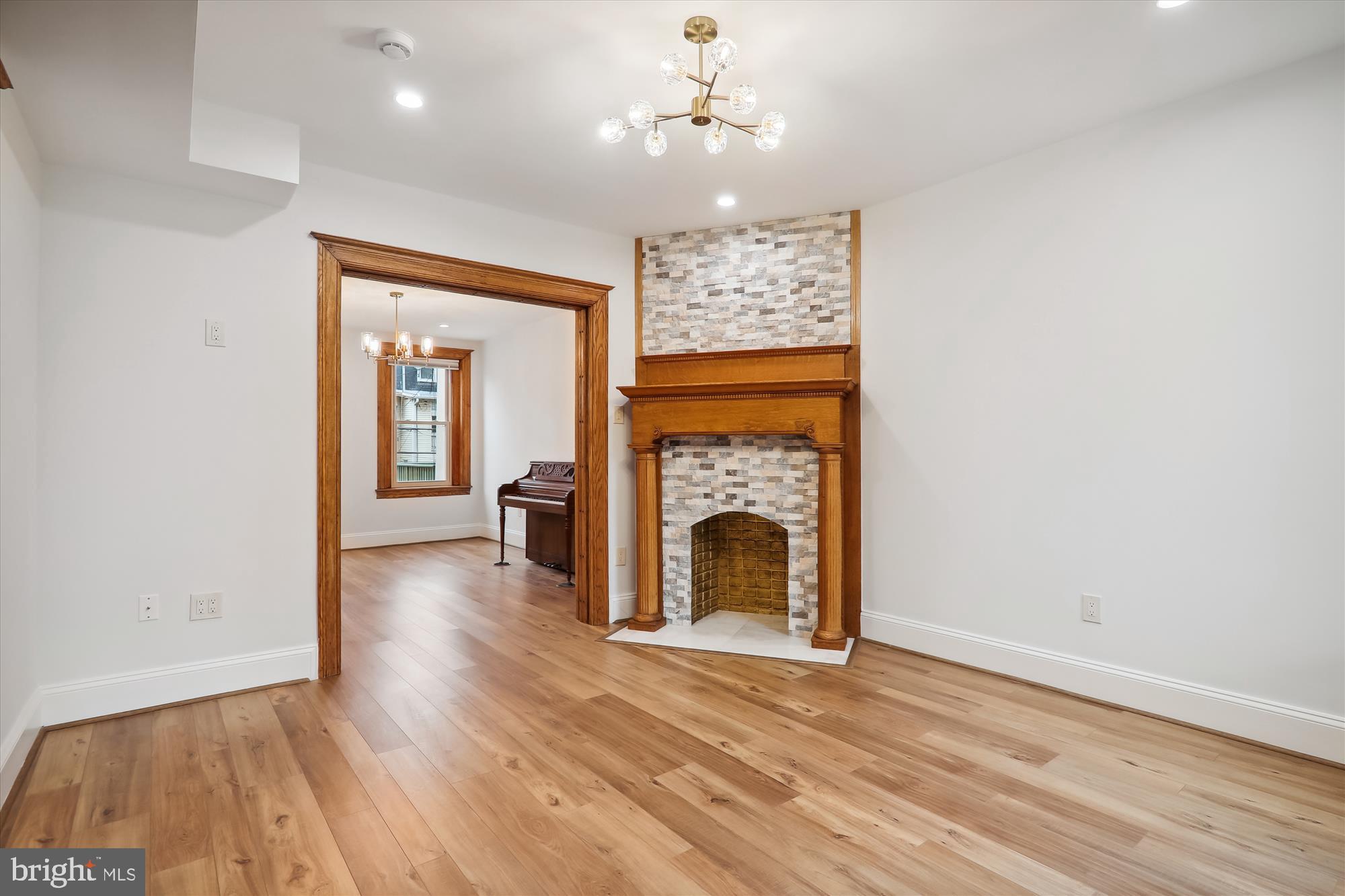721 Quebec Place Northwest Washington, DC 20010 - Photo 17 of 77 a view of a livingroom with a fireplace a chandelier and wooden floor