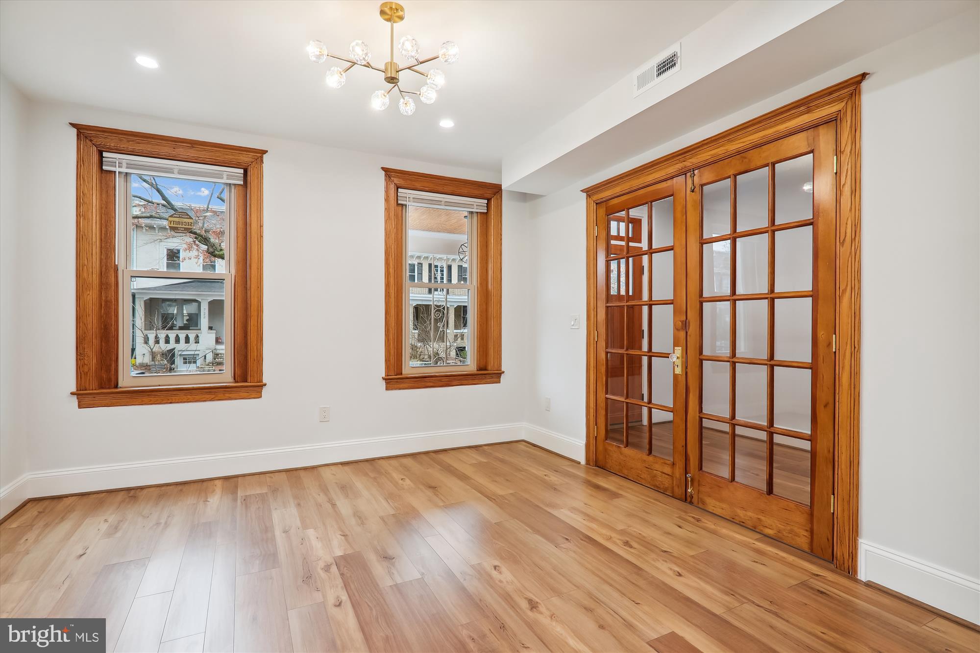 721 Quebec Place Northwest Washington, DC 20010 - Photo 19 of 77 an empty room with wooden floor and windows
