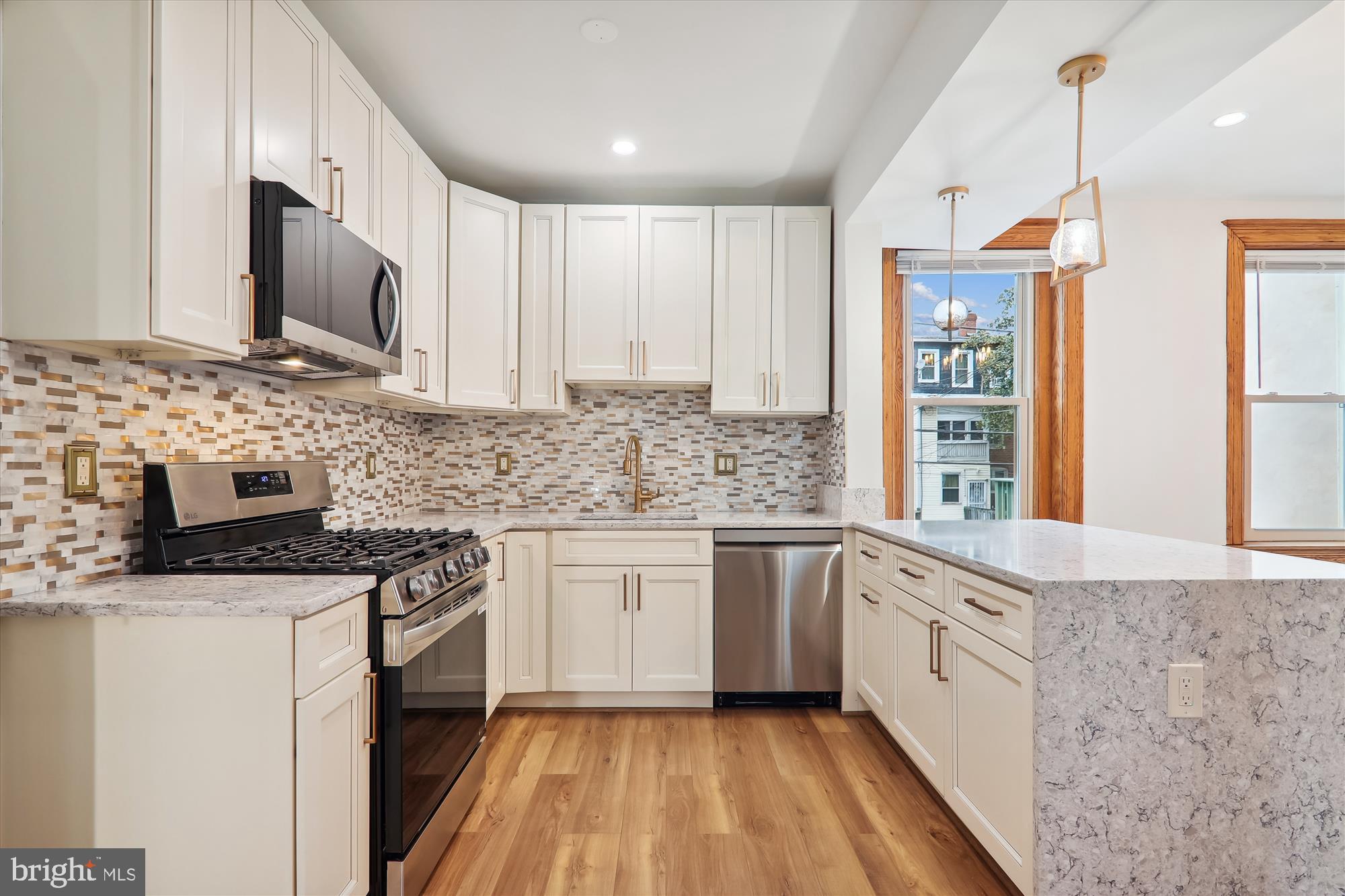 721 Quebec Place Northwest Washington, DC 20010 - Photo 2 of 77 a kitchen with stainless steel appliances granite countertop a sink stove and microwave