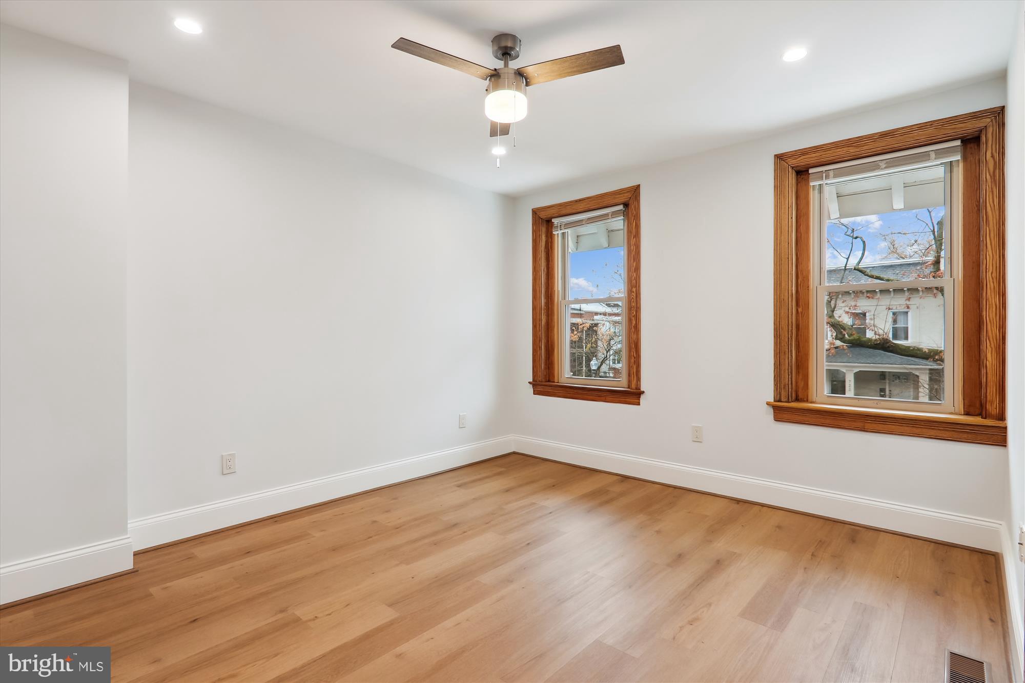 721 Quebec Place Northwest Washington, DC 20010 - Photo 31 of 77 an empty room with wooden floor ceiling fan and windows