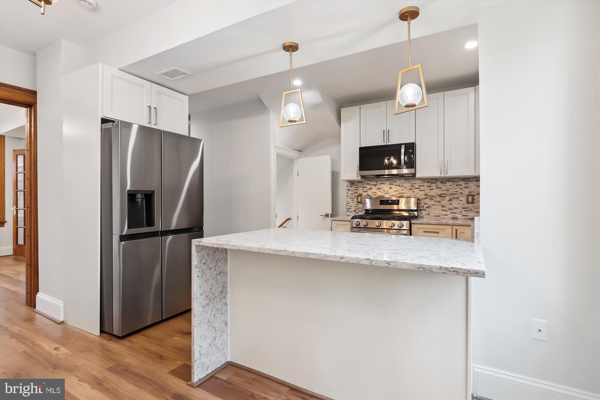 721 Quebec Place Northwest Washington, DC 20010 - Photo 10 of 77 a kitchen with kitchen island a counter top space a refrigerator and a sink