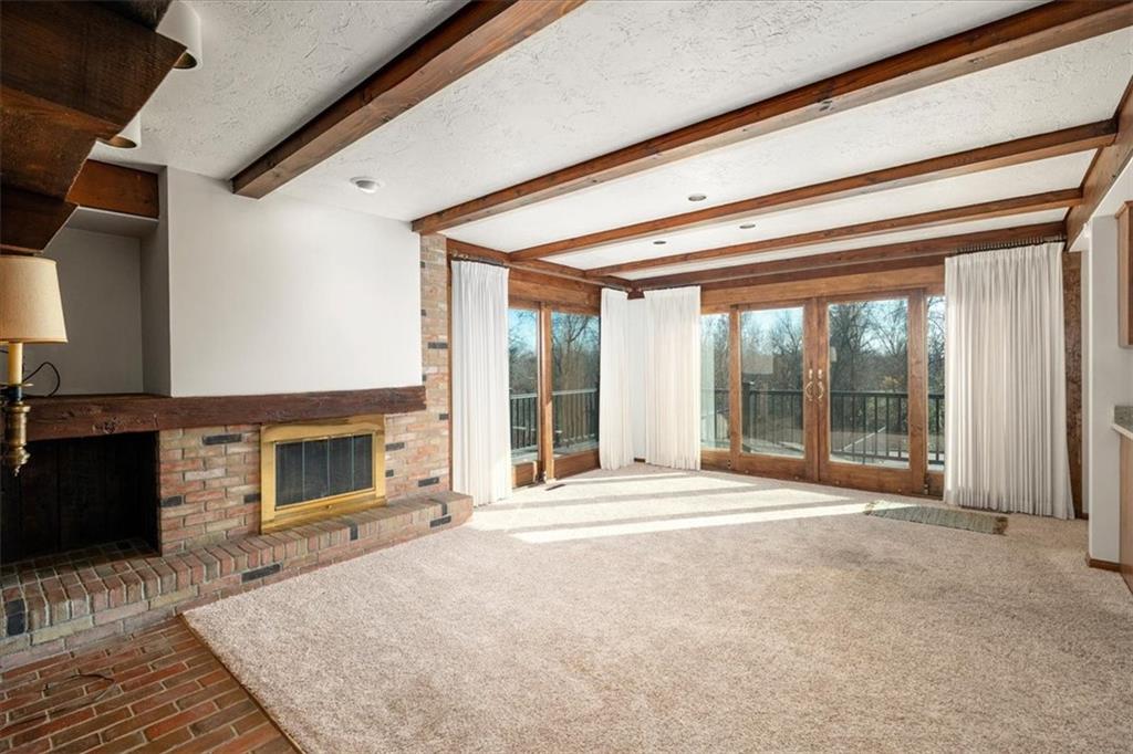 1925 Tuscarawas Road Beaver, PA 15009 - Photo 7 of 44 a living room with a fireplace and large windows