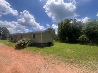 a view of a house with a yard and garage