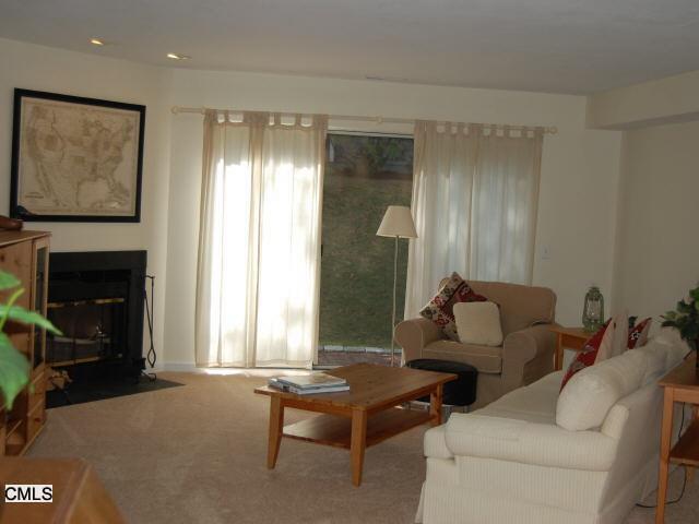 23 Glen Ridge, Unit 23 Wilton, CT 06897 - Photo 1 of 1 a living room with furniture and a fireplace