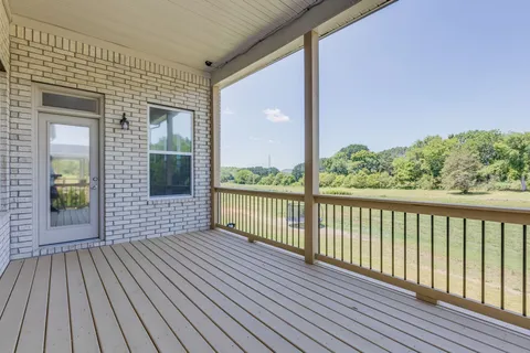 a view of a balcony with wooden floor