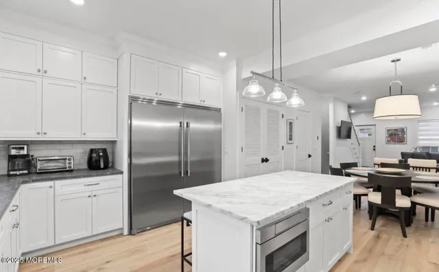 a kitchen with cabinets and stainless steel appliances