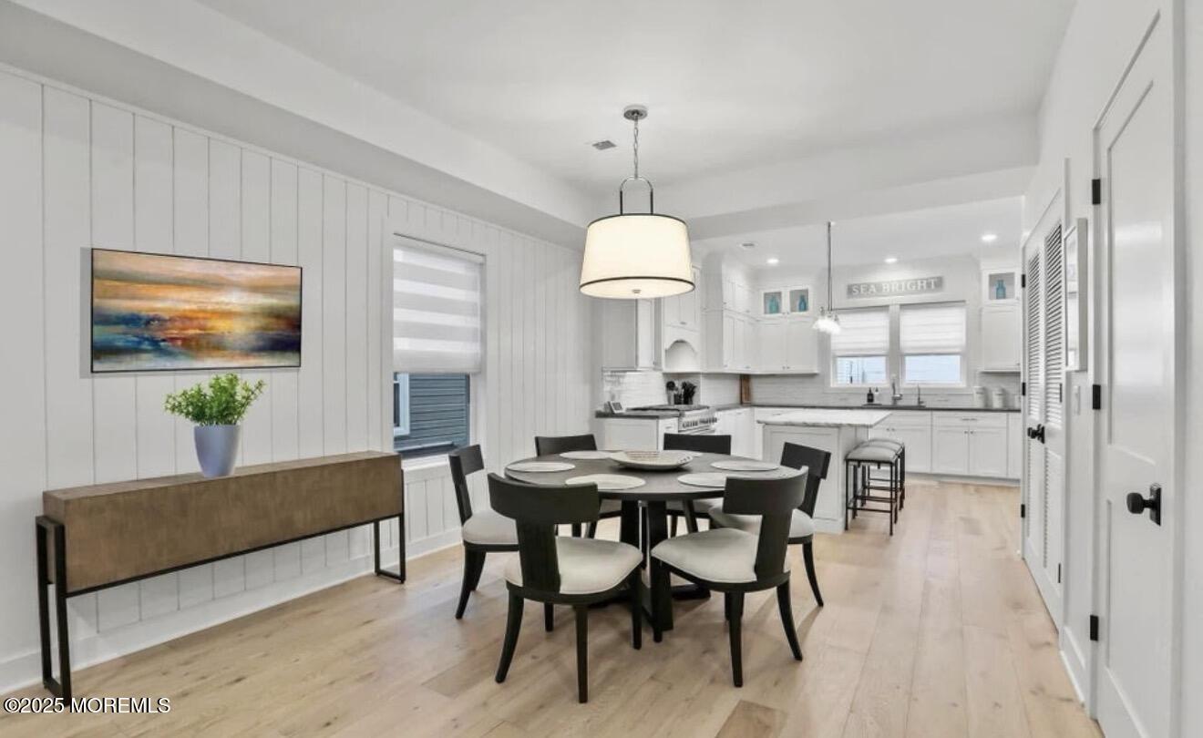7 Center Street, Unit JUNE Sea Bright, NJ 07760 - Photo 6 of 19 a view of a dining room with furniture and a chandelier