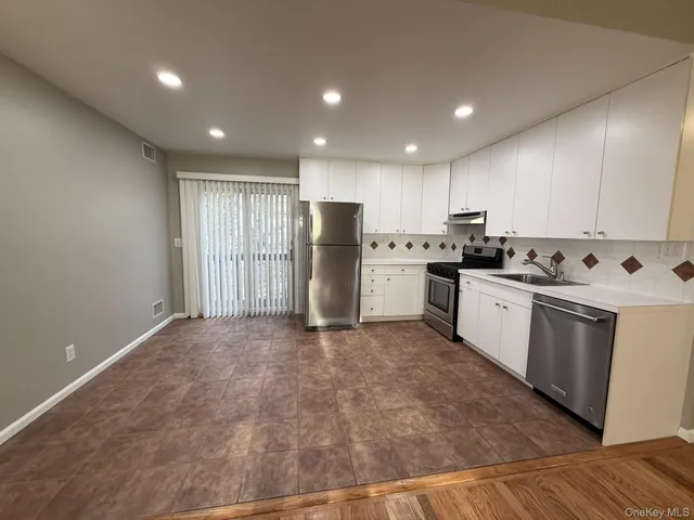 a kitchen with stainless steel appliances granite countertop a refrigerator sink and cabinets