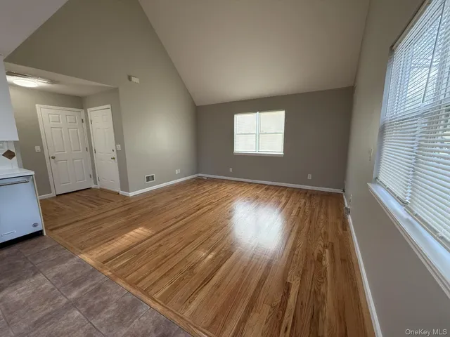 a view of a room with wooden floor and window