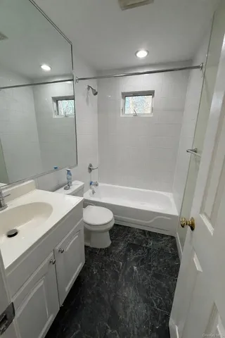 a bathroom with a double vanity sink toilet and shower