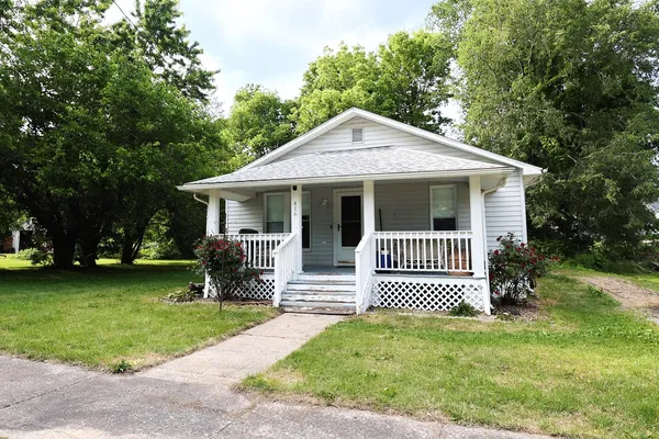 a front view of a house with a garden