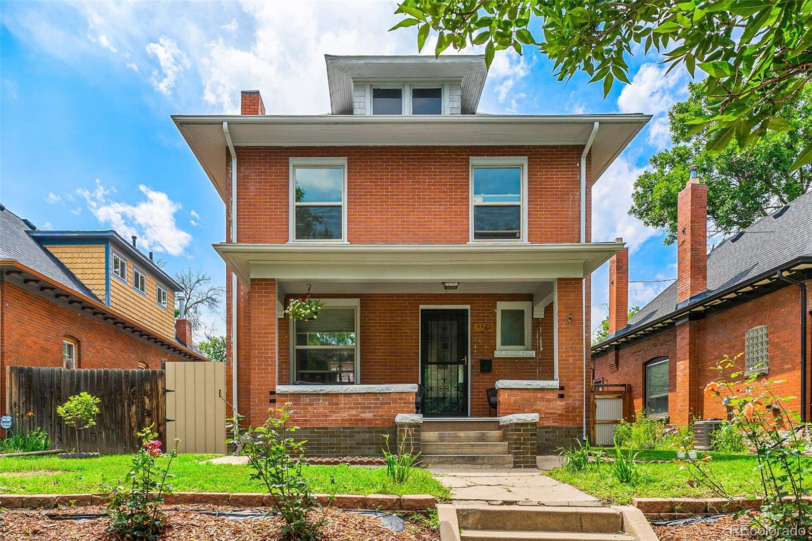 4425 Alcott Street Denver, CO 80211 - Photo 1 of 40 a front view of a house with garden