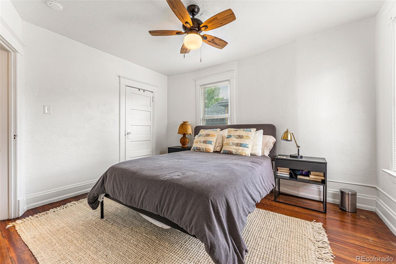 4425 Alcott Street Denver, CO 80211 - Photo 21 of 40 a bedroom with a bed and wooden floor