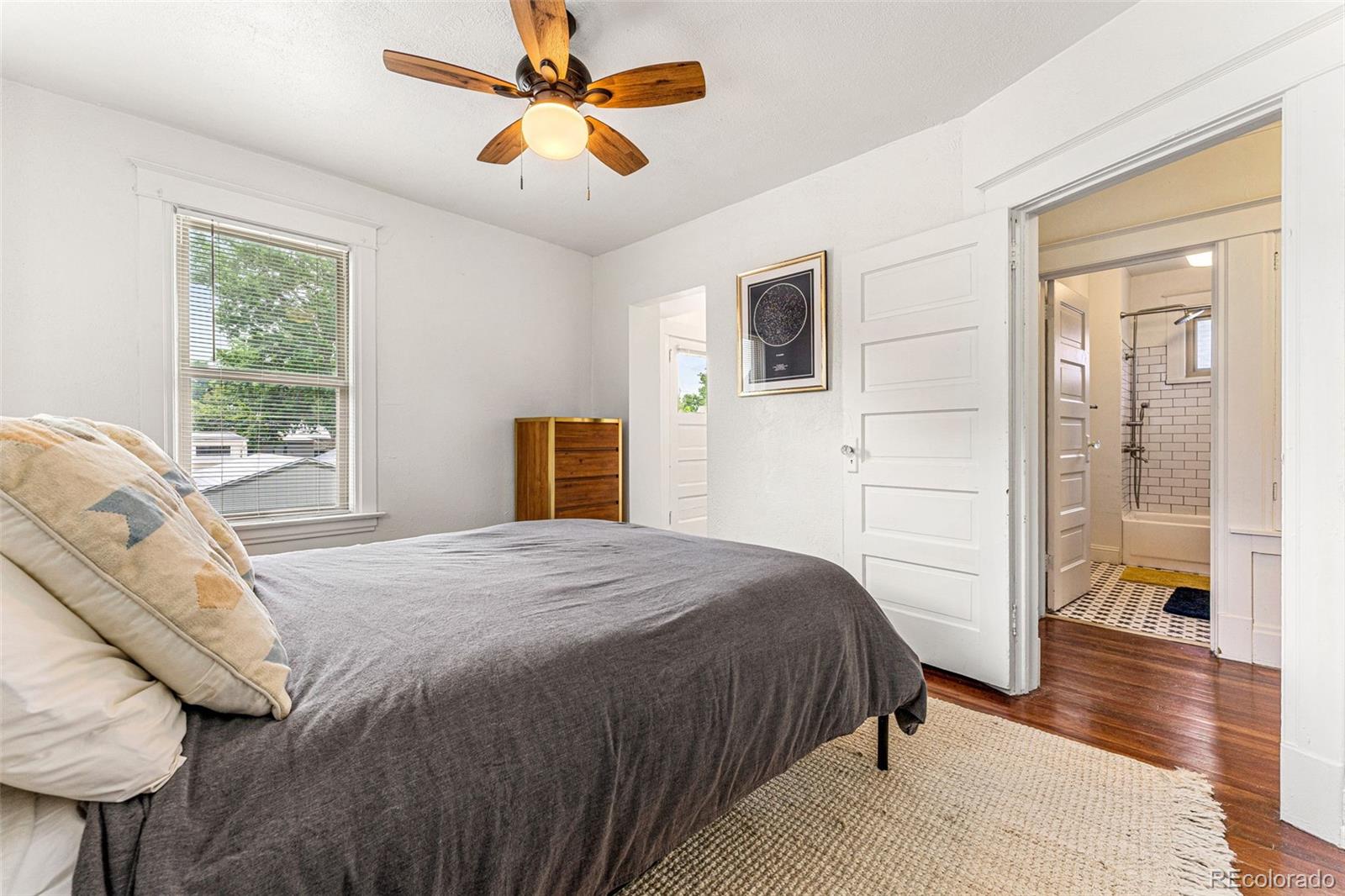 4425 Alcott Street Denver, CO 80211 - Photo 22 of 40 a bedroom with a bed and a chandelier