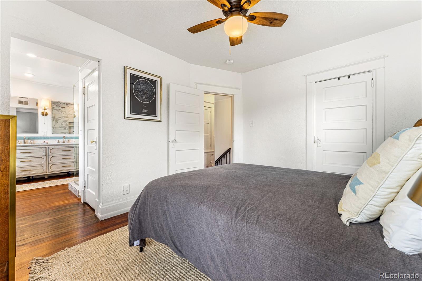 4425 Alcott Street Denver, CO 80211 - Photo 23 of 40 a bedroom with a bed and wooden floor
