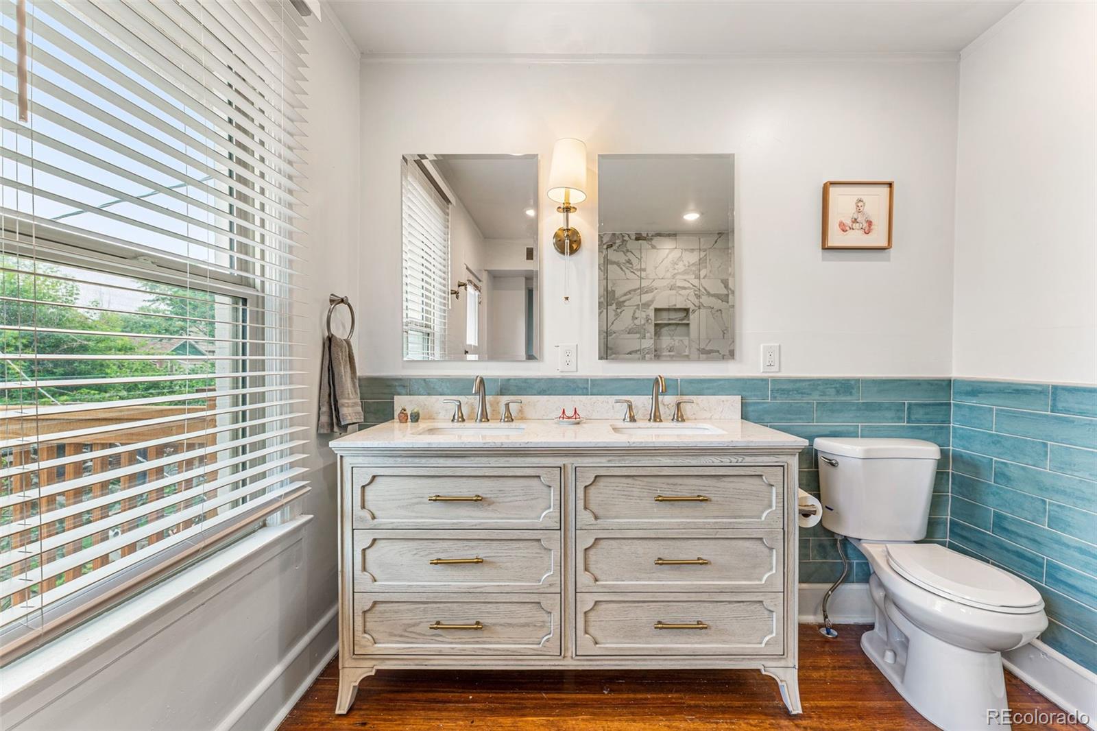4425 Alcott Street Denver, CO 80211 - Photo 25 of 40 a bathroom with a sink a toilet and a mirror