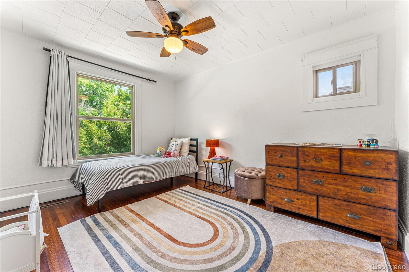 4425 Alcott Street Denver, CO 80211 - Photo 27 of 40 a bedroom with a bed and a chandelier