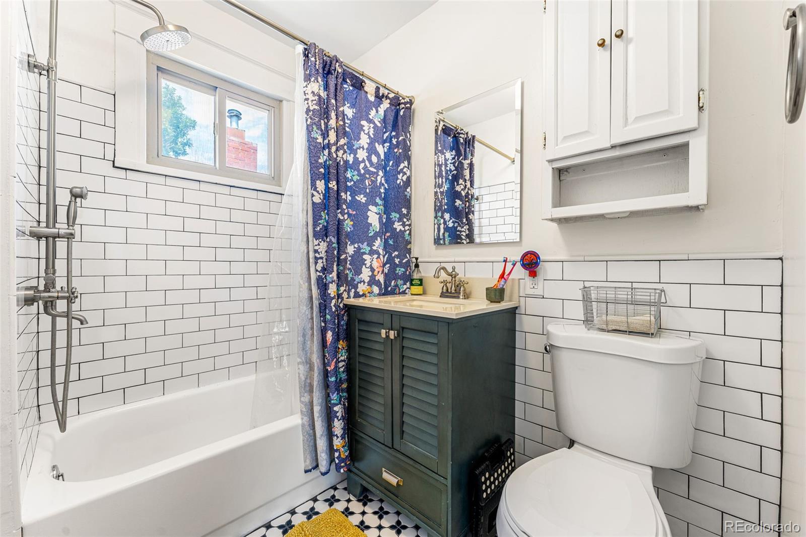 4425 Alcott Street Denver, CO 80211 - Photo 29 of 40 a bathroom with a sink toilet vanity and tub