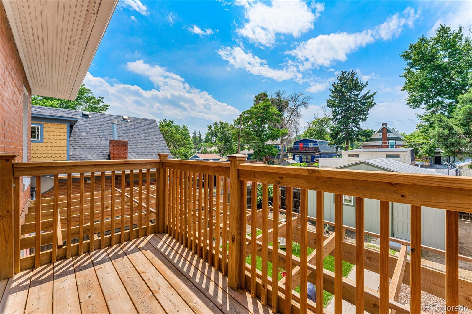 4425 Alcott Street Denver, CO 80211 - Photo 30 of 40 a view of a balcony with wooden floor and fence