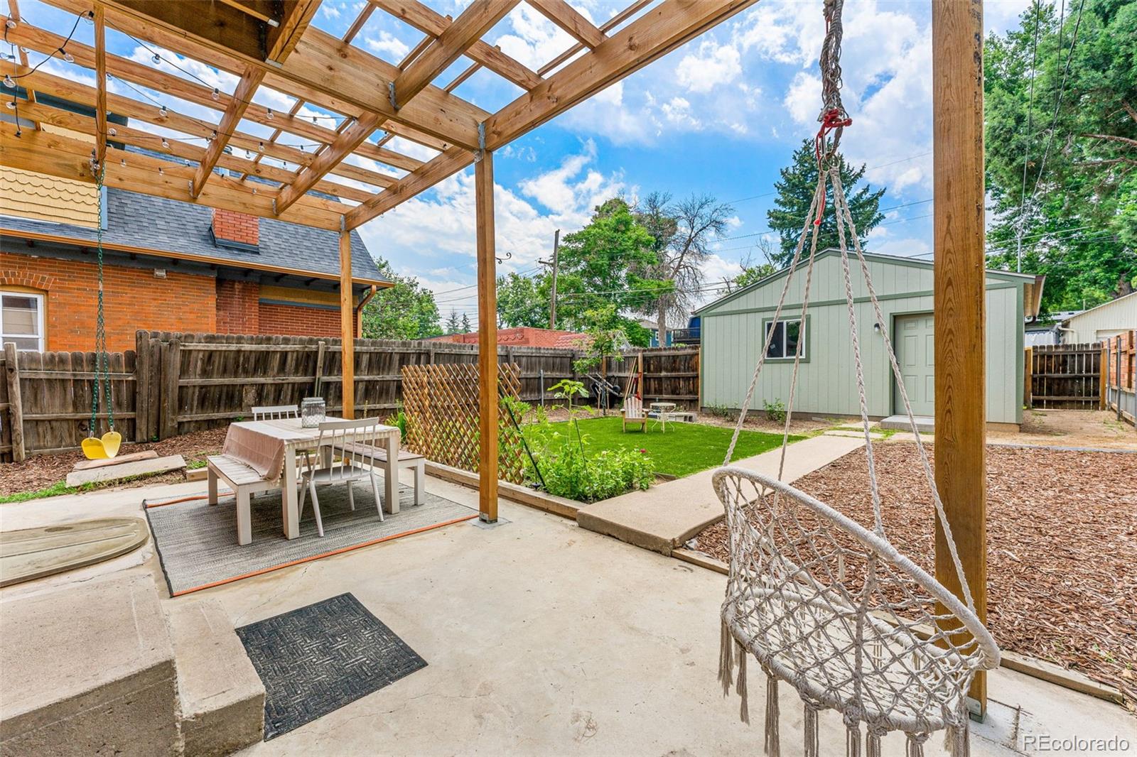 4425 Alcott Street Denver, CO 80211 - Photo 38 of 40 a view of a patio with a table and chairs next to a yard
