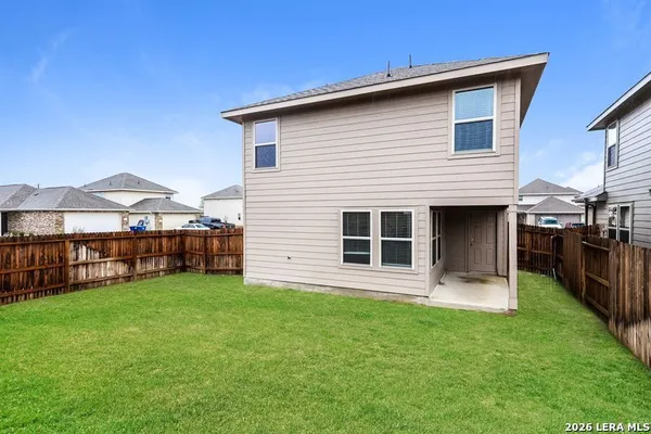 a view of a house with a yard and sitting area