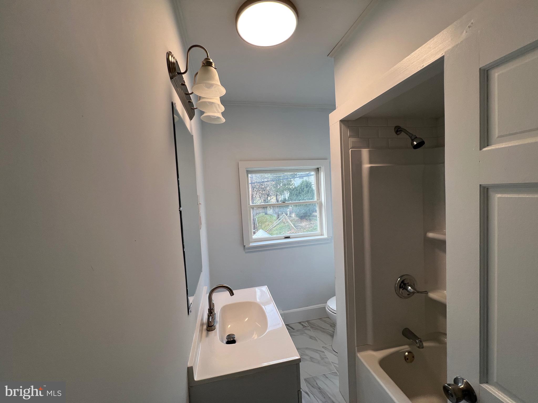 405 North Front Street Minersville, PA 17954 - Photo 14 of 32 a bathroom with a tub sink and mirror