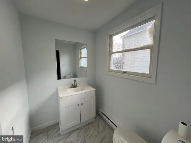 a large kitchen with stainless steel appliances granite countertop a stove and a large window