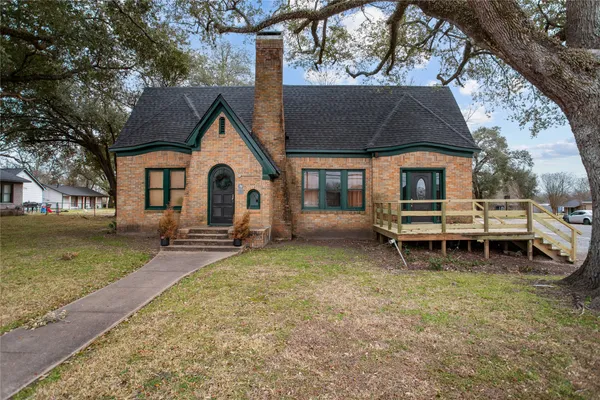 a view of a house with a yard and sitting area