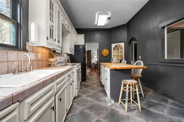 a kitchen with stainless steel appliances kitchen island granite countertop a sink and cabinets