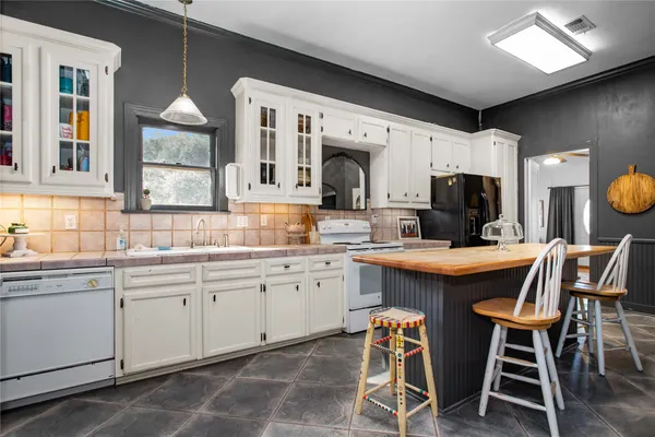 a kitchen with granite countertop counter space dining table and stainless steel appliances