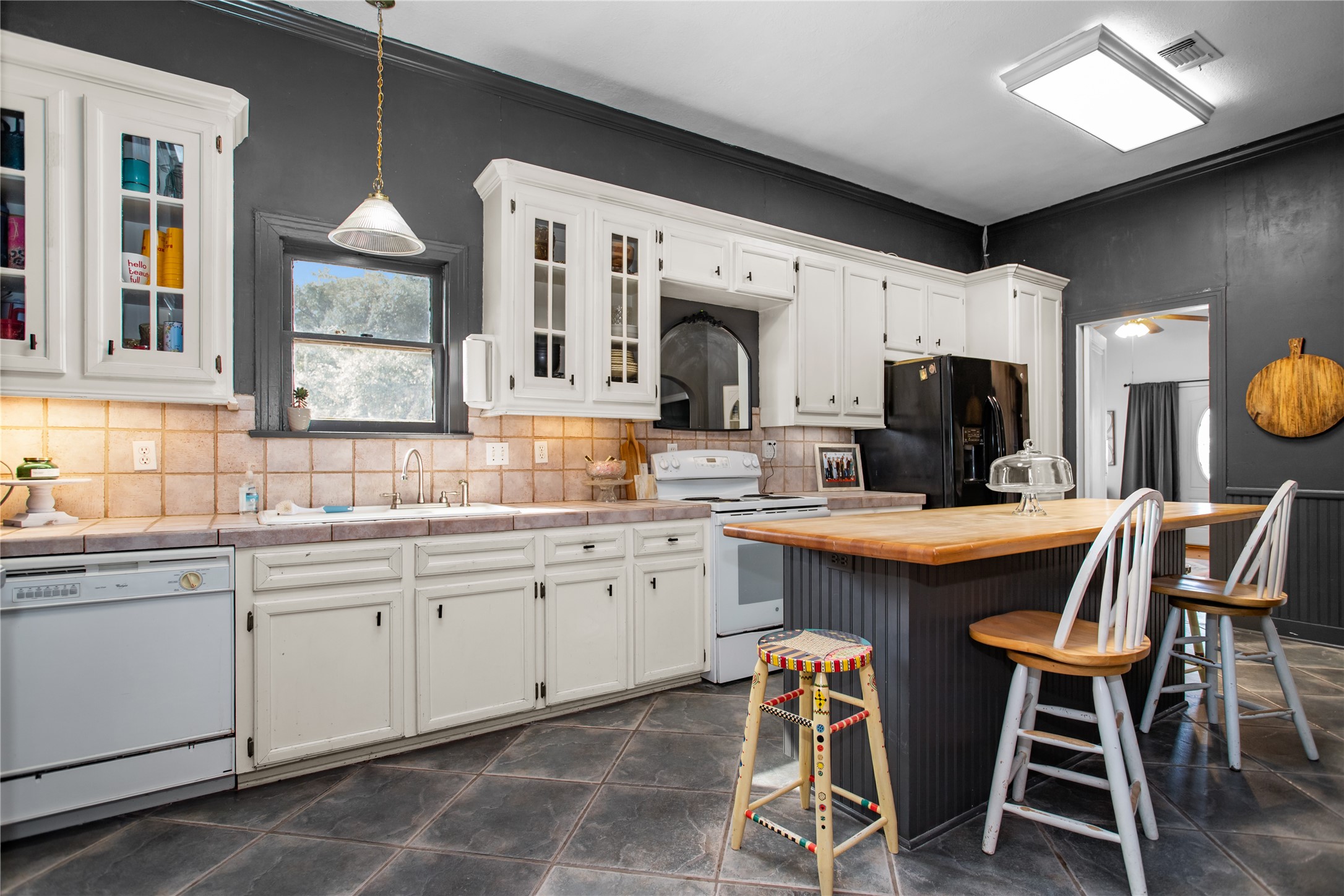 706 East Main Street Madisonville, TX 77864 - Photo 12 of 25 a kitchen with granite countertop counter space dining table and stainless steel appliances
