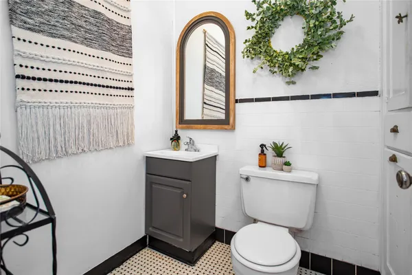 a bathroom with a toilet a sink and mirror