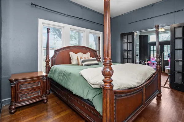 a bed sitting in a bedroom next to a window