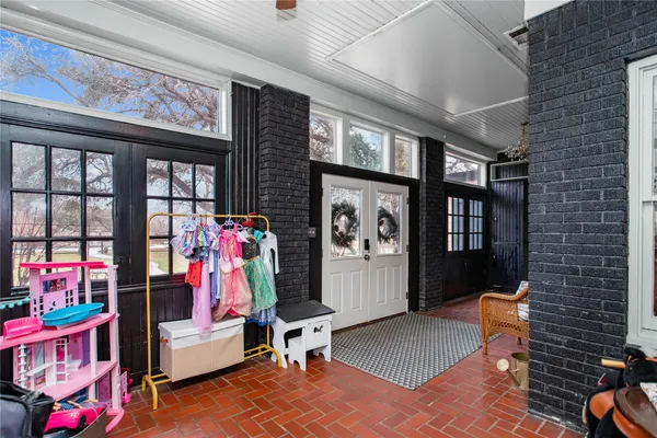 a living room with furniture a window and gym equipment