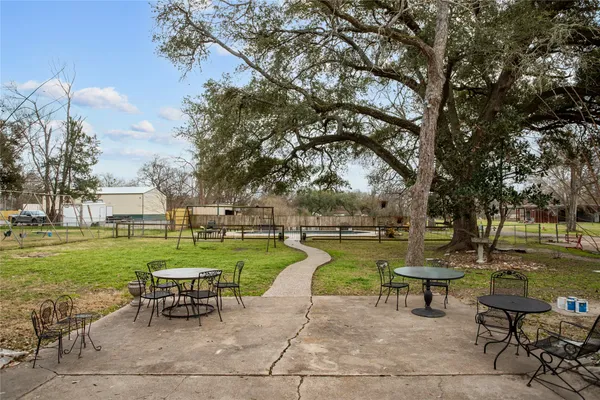 a view of a swimming pool and lounge chairs in back yard