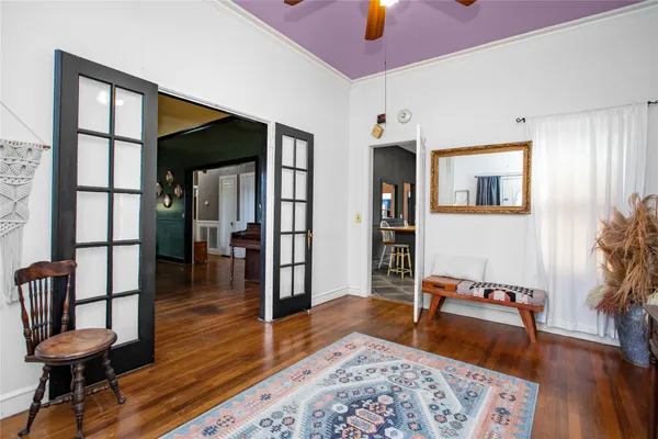 a living room with furniture and wooden floor
